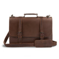 Front view of the Hide & Drink two-compartment chunky messenger bag, showcasing its spacious design and laptop compartment. This rustic briefcase with adjustable shoulder strap is a durable messenger bag and ideal travel accessory, crafted from premium full-grain leather with artisanal details cut and sewn by hand. Produced in La Antigua, Guatemala and Oaxaca, Mexico.