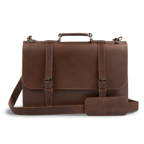 Front view of the Hide & Drink two-compartment chunky messenger bag, showcasing its spacious design and laptop compartment. This rustic briefcase with adjustable shoulder strap is a durable messenger bag and ideal travel accessory, crafted from premium full-grain leather with artisanal details cut and sewn by hand. Produced in La Antigua, Guatemala and Oaxaca, Mexico.