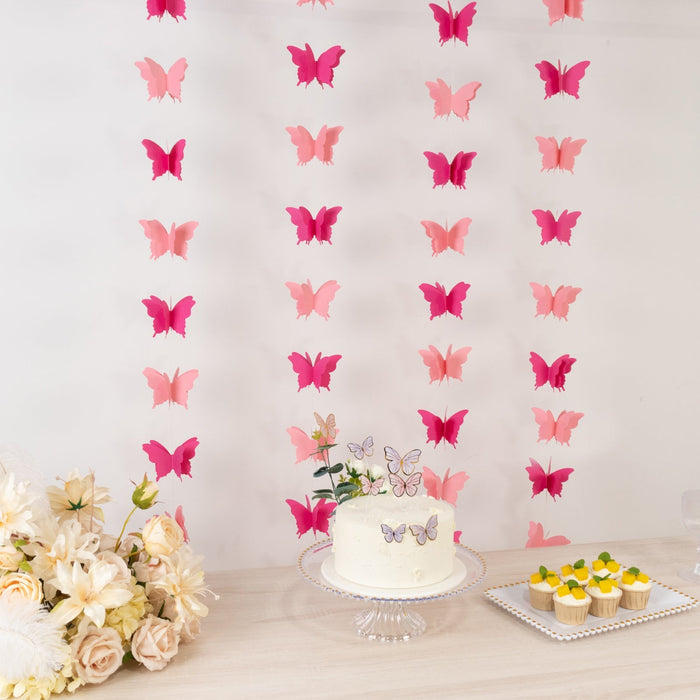 Butterfly decoration backdrop with cake and cupcakes at a celebration.