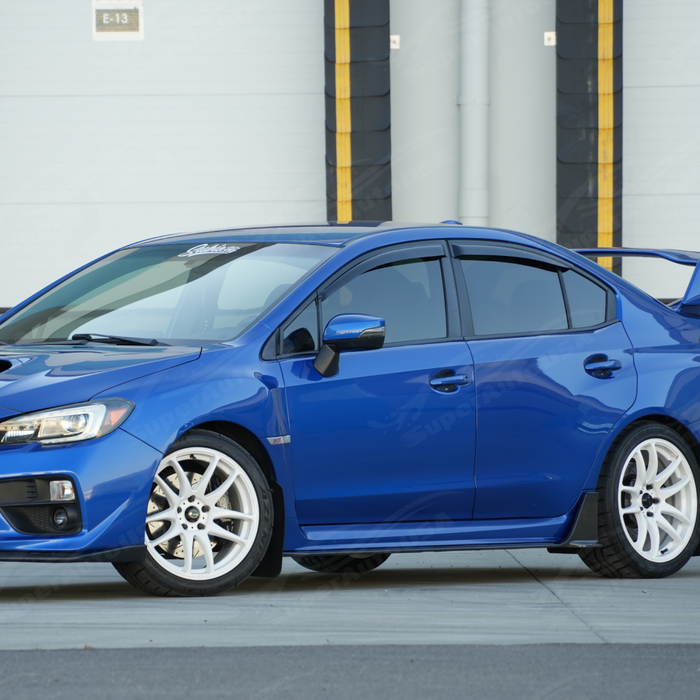 Glossy carbon fiber winglet side skirts providing sharp contrast on a World Rally Blue Subaru STI