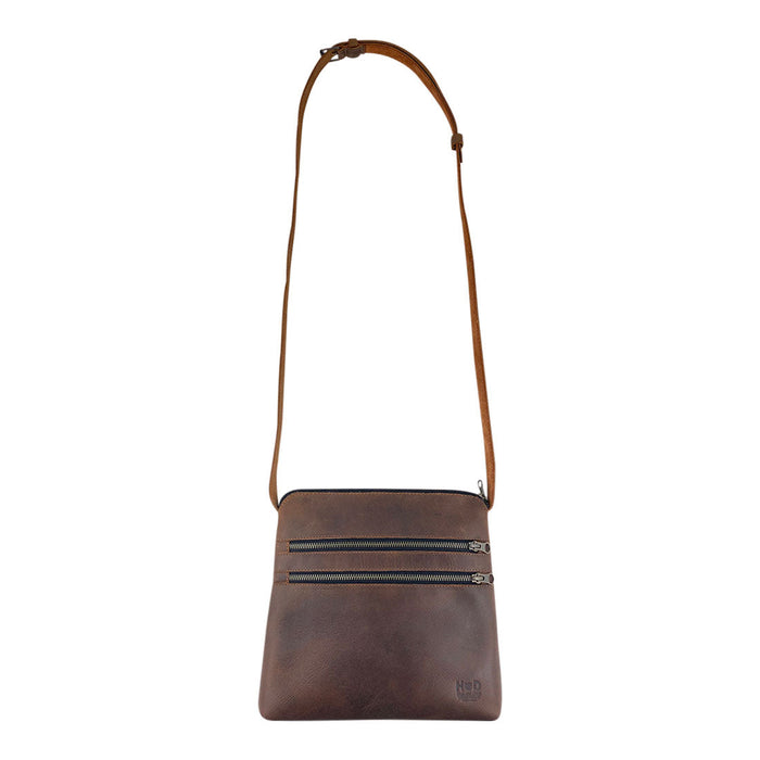Front view of the 3 Zipper Satchel by Hide & Drink, showcasing its handmade design from durable full grain leather and plaid cotton. This versatile handbag features twin zippered pockets and is perfect for everyday use. 3 Zipper Satchel - Versatile Handbag, Handmade from Full Grain Leather and Plaid Cotton, Small Batch Production, Hand Cut, Hand Sewn, Fire Branded, Artisan, Handmade in La Antigua Guatemala & Oaxaca Mexico.