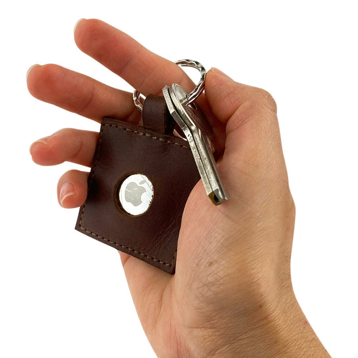 Person holding the AirTag Squared Keychain by Hide & Drink, featuring a Full Grain Leather exterior. This stylish accessory makes it easy to keep your personal items tracked with a durable keyring. Squared AirTag Keychain, handmade by artisans in La Antigua Guatemala & Oaxaca Mexico.