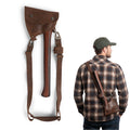 Axe Head Sheath with Shoulder Strap by Valhalla Gear, shown in use with a user wearing it across the back, demonstrating its practical utility. This riveted carrier for lumberjacks is made from full grain leather and makes an excellent accessory for tools and home improvement, handmade with care in La Antigua Guatemala.