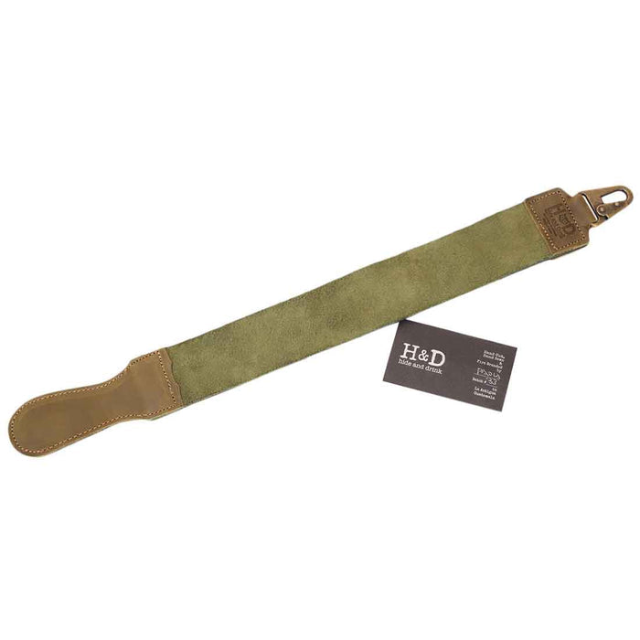Hide & Drink's Olive Green Barber Strop displayed with a straight razor, perfect for barbers. This handmade Full Grain Leather shaving sharpener merges functionality and artisan craftsmanship.