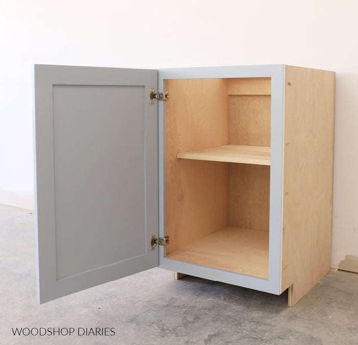DIY base cabinet with door open showing interior shelf storage