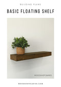 Wooden floating shelf with a plant on a white wall, featuring 'Woodshop Diaries' branding.