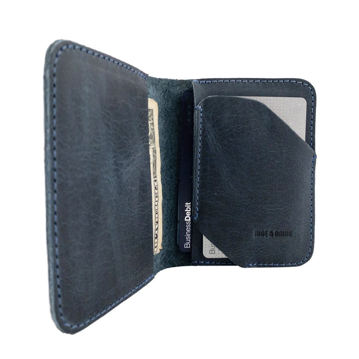 Open view of the Bi-Fold Card Wallet Diagonal by Hide & Drink in brown, illustrating its functionality as a stylish cash and card organizer made from durable leather.