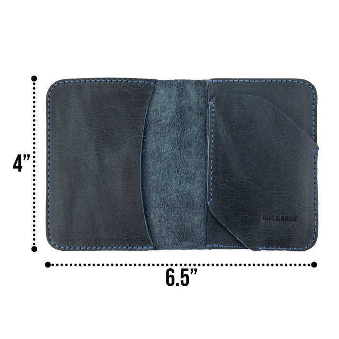 Inside view of the Bi-Fold Card Wallet Diagonal by Hide & Drink in navy-colored full grain leather, showcasing minimalist style while holding cards and folded cash.