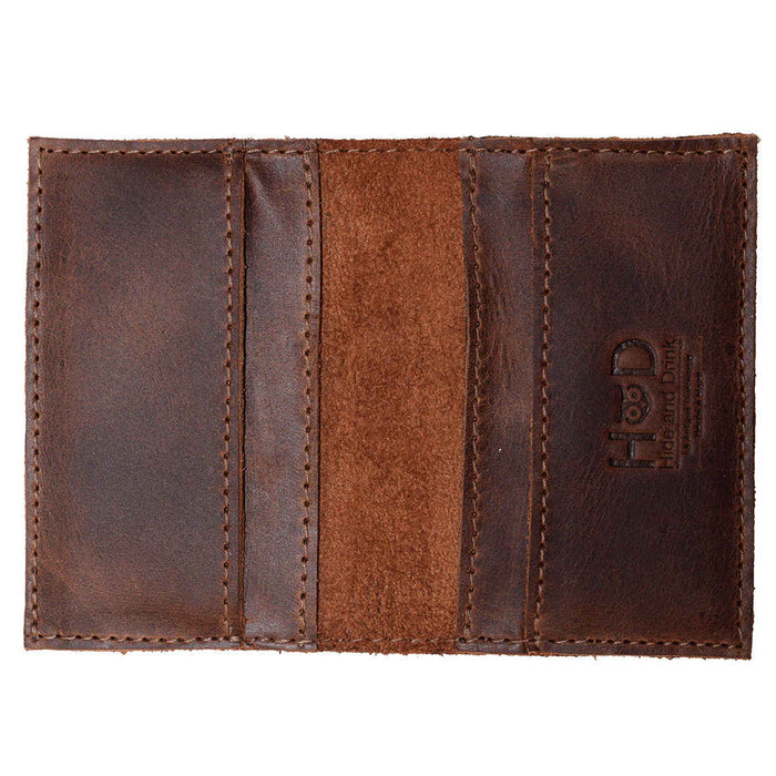 Bifold Horizontal Card Wallet by Hide & Drink displayed from the outside, highlighting its vintage look and durability, suitable for a minimalist traveller, organizer with capacity for multiple items, crafted from full grain leather, features small batch production, hand cut, hand sewn, and fire branded artistry, made by artisans in La Antigua Guatemala & Oaxaca Mexico.