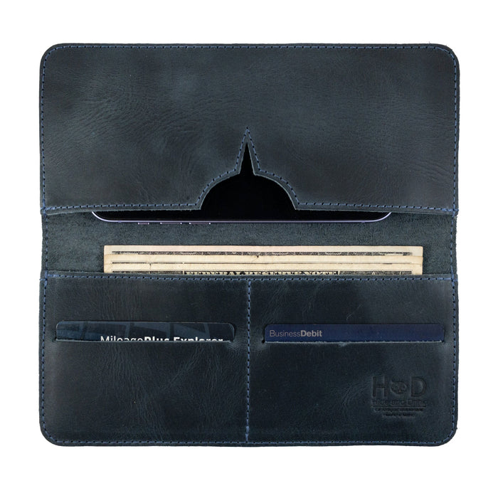 A view of the closed bifold wallet for cellphone by Hide & Drink, showcasing a minimalist design. This sleek Bifold Wallet for Cellphone is made from high-quality Full Grain Leather, reflecting fine artisan skills. Each piece is created through small batch production in La Antigua Guatemala & Oaxaca Mexico.