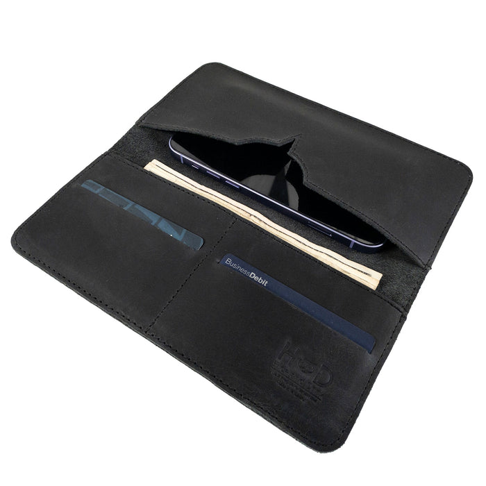 Exterior view of the closed black bifold wallet for cellphone by Hide & Drink, emphasizing its sleek design. This Bifold Wallet for Cellphone combines functionality with style, crafted from high-quality Full Grain Leather. Experience the unique artisan touch from small batch production in La Antigua Guatemala & Oaxaca Mexico.