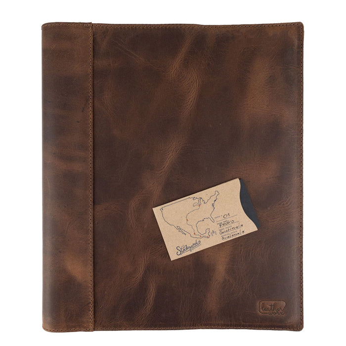A detailed shot of a leather binder cover by Leather Worx featuring the dimensions prominently. This organizer is a classy representation of minimalist style in office accessories, constructed from durable full grain leather. Handmade in La Antigua Guatemala, it highlights artisan craftsmanship, fire branding, and small batch production.