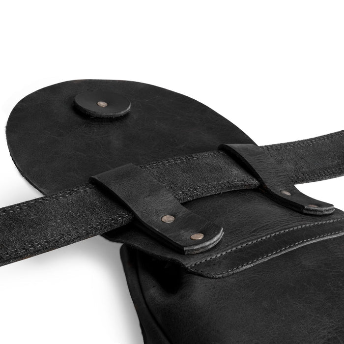 Close-up of the strap and fasteners on the black Valhalla Gear Bushcraft Bag, emphasizing its quality craftsmanship and secure design as a portable safe pouch for valuables.