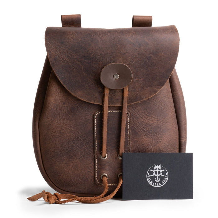 Valhalla Gear Bushcraft Bag with an authenticity card, showcasing its artisan quality as a portable safe pouch made of full grain leather. This handmade bag is ideal for securely storing valuables.