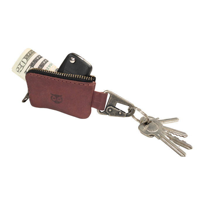 An open Car Key Holder by Hide & Drink, demonstrating its capacity for holding cash and keys seamlessly. This functional accessory also serves as a case for Headphone and charging Cables, Memory Cards, and Flash Drives. Crafted from Full Grain Leather with a Nickel Metal Clasp, embodying artisan quality from Small Batch Production in La Antigua Guatemala & Oaxaca Mexico.