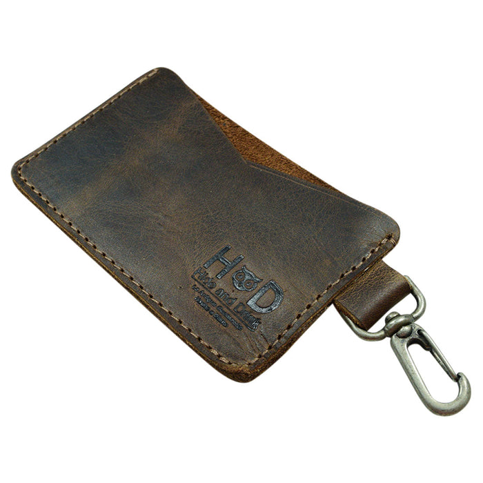 Side view of the Leather Card & Key Holder from Hide & Drink, emphasizing its minimalist design. This stylish organizer can hold up to 4 cards and serves as an efficient Keychain Organizer. Crafted from Full Grain Leather, the item is hand cut, hand sewn, and fire branded, demonstrating artisan skills from small batch production in La Antigua Guatemala & Oaxaca Mexico.