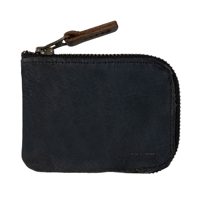 A close-up of a black Hide & Drink Card Pocket Wallet showing its quality craftsmanship. This zippered card wallet for men and women is an excellent coin pouch and money holder, artisan made from full grain leather in La Antigua Guatemala, emphasizing fire branded details.
