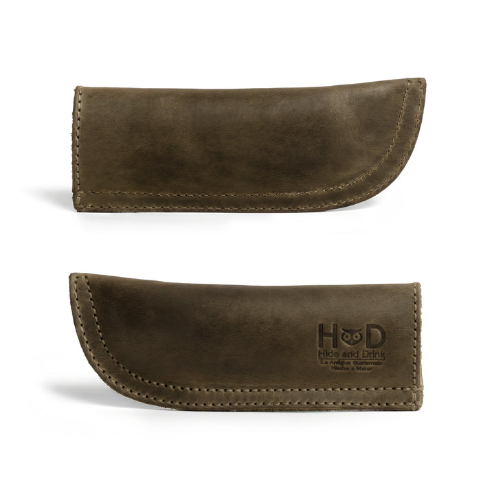 Hide & Drink Cast Iron Panhandle Cover showcased against a clean background. This artisan hot handle protector is made from durable full grain leather and features a double stitched design for strength. Handmade in La Antigua Guatemala & Oaxaca Mexico, it enhances both the safety and style of your kitchen.
