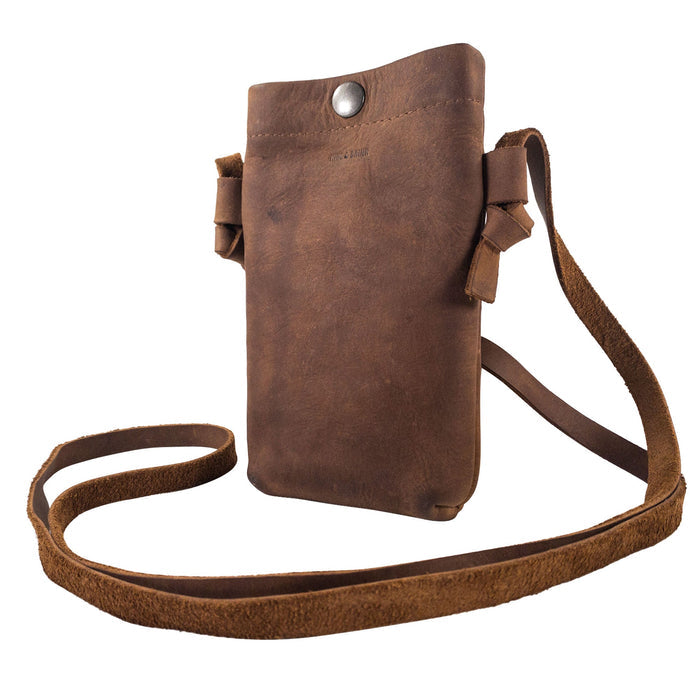 Side angle of the Hide & Drink Cell Phone Shoulder Bag, featuring a unique design with its soft full grain leather. This versatile shoulder bag or crossbody bag for cellphone use combines style and functionality, crafted with care by artisans in La Antigua Guatemala & Oaxaca Mexico, emphasizing quality and small batch production.