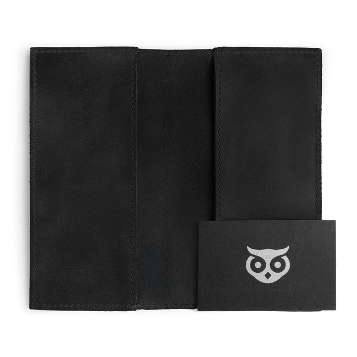 Inside view of the Checkbook Leather Cover by Hide & Drink in black, serving as a minimalist organizer for standard checkbooks. Crafted from full grain leather, this handmade item demonstrates the skills of artisans in La Antigua Guatemala and Oaxaca Mexico with a focus on small batch production.