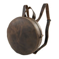 Heather's Circular Backpack featuring a round, full grain leather design, perfect as a travel accessory or casual daypack. This backpack includes adjustable straps and showcases the craftsmanship of small batch production, being hand cut and hand sewn by artisans in La Antigua Guatemala & Oaxaca Mexico.