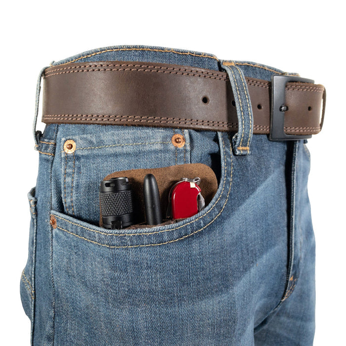 The Compact EDC Tool Holster by Valhalla Gear positioned in a jeans pocket, demonstrating its sleek design. Made from full grain leather with a rustic charm, this pocket case is ideal for carrying tools daily. Handcrafted in La Antigua Guatemala, it embodies small batch production excellence.
