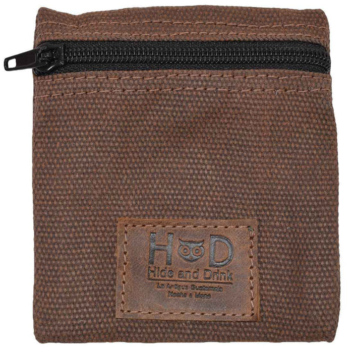 Hide & Drink Condom Pouch highlighted against a neutral background, made from premium water resistant waxed canvas. Perfect for every day use, this classic partner gift is a great travel essential. Handmade in La Antigua Guatemala ensures small batch quality and artisan skills.