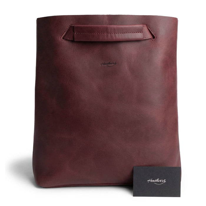 Front view of Heather's Convertible Backpack to Shoulder Bag, highlighting its sophisticated maroon finish and unique handle. This spacious crossbody for women is constructed from Full Grain Leather, embodying the essence of small batch production and artisan expertise through hand cut and hand sewn techniques. Handmade in La Antigua Guatemala & Oaxaca Mexico.