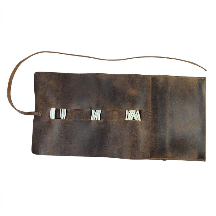 Hide & Drink Cord Pouch with an elegant design, showcasing its cord organizer capabilities. This durable travel bag is handcrafted from full grain leather, perfect for keeping your cables tidy. Artisan made through small batch production in La Antigua Guatemala & Oaxaca Mexico.