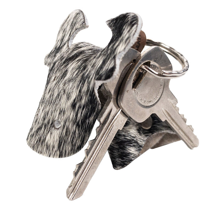 Unique Cow Shape Keychain from Western Leather Works displayed with keys, made from Hair-On-Hide Full Grain Leather. This beautiful artisan piece reflects the hand cut and hand sewn craftsmanship characteristic of small batch production, a perfect blend of style and function from La Antigua Guatemala and Oaxaca Mexico.