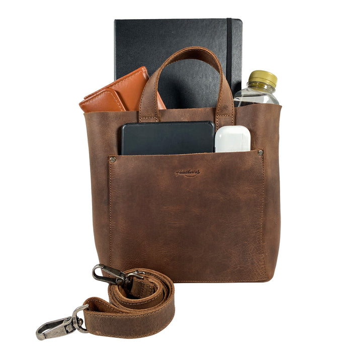 Heather's Crossbody Tote Bag with Pouch, filled with essentials for a day out, demonstrating its functionality as a classy purse. Made from high-quality full grain leather, this vintage style shoulder case is an artisan creation, handmade in La Antigua Guatemala & Oaxaca Mexico.