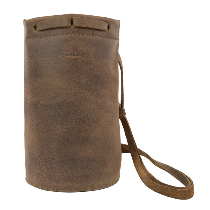 Heather's Cylinder Shoulder Phone Bag showcasing a stylish cylinder-shaped purse with an adjustable shoulder strap. This durable crossbody bag is made from full grain leather, highlighting the artisan craftsmanship from StockyardX, emphasizing small batch production and hand cut, hand sewn techniques. Handmade in La Antigua Guatemala & Oaxaca Mexico.