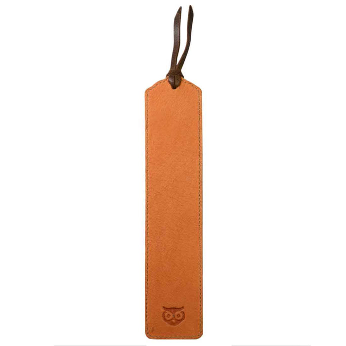 Deluxe Long Bookmark (2 Pack) by Hide & Drink with a single light brown leather bookmark featuring an owl engraving. This lovely reversible page marker is a classic book or journal accessory for reading lovers, made from full grain leather, emphasizing stockyardX, small batch production, hand cut, hand sewn, fire branded, artisan craftsmanship, handmade in La Antigua Guatemala & Oaxaca Mexico.