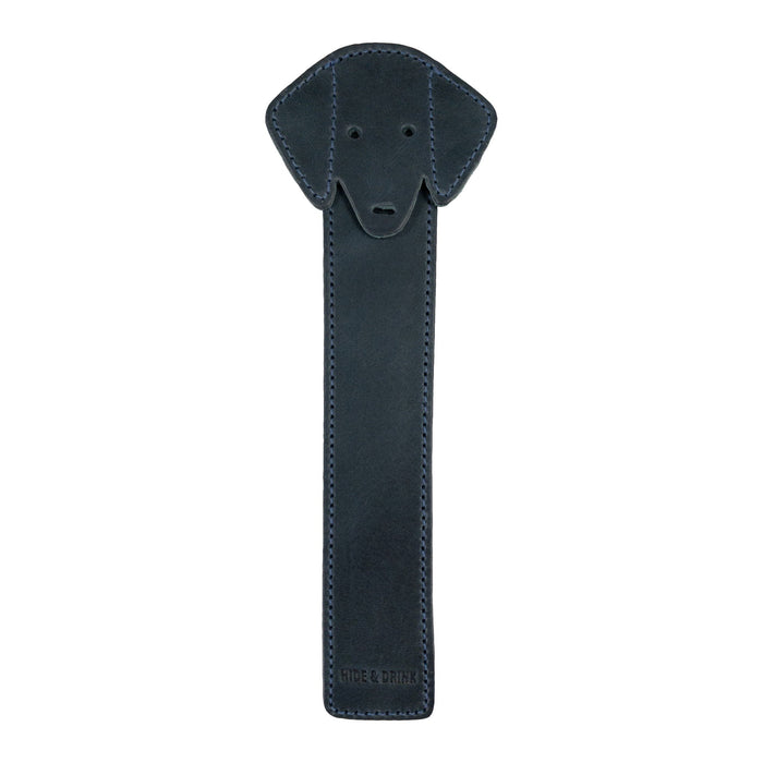 The front view of Hide & Drink's navy Dog Bookmark made from Full Grain Leather, showcasing its charming dog face design. This artisan bookmark is handcrafted with small batch production quality and fire branding from La Antigua Guatemala & Oaxaca Mexico.