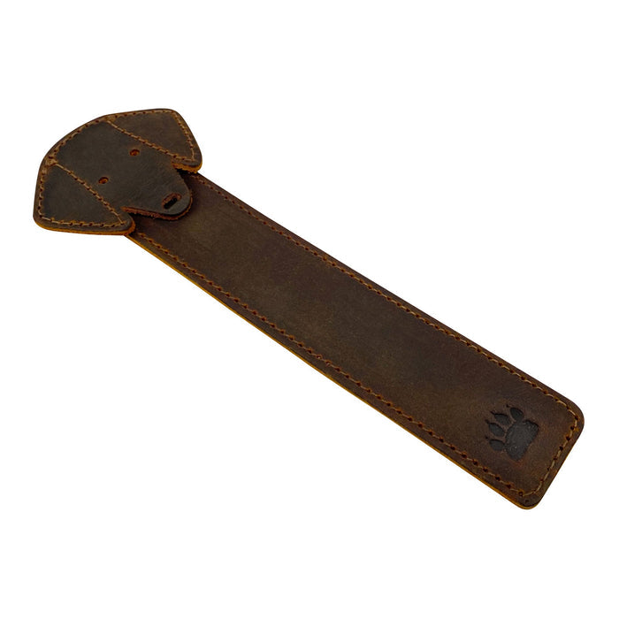 Taco Dog Dog Bookmark displayed on a table, emphasizing its cute dog head design and durable construction. This rustic colored full grain leather bookmark is an exceptional gift for dog and book lovers, created with artisan techniques in La Antigua Guatemala.