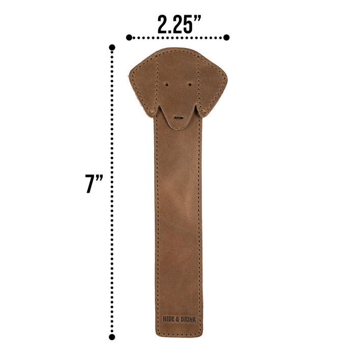 The front view of Hide & Drink's brown Dog Bookmark made from Full Grain Leather, showcasing a smiling dog design. This handmade bookmark highlights the spirit of small batch production and fire branding, crafted in La Antigua Guatemala & Oaxaca Mexico.