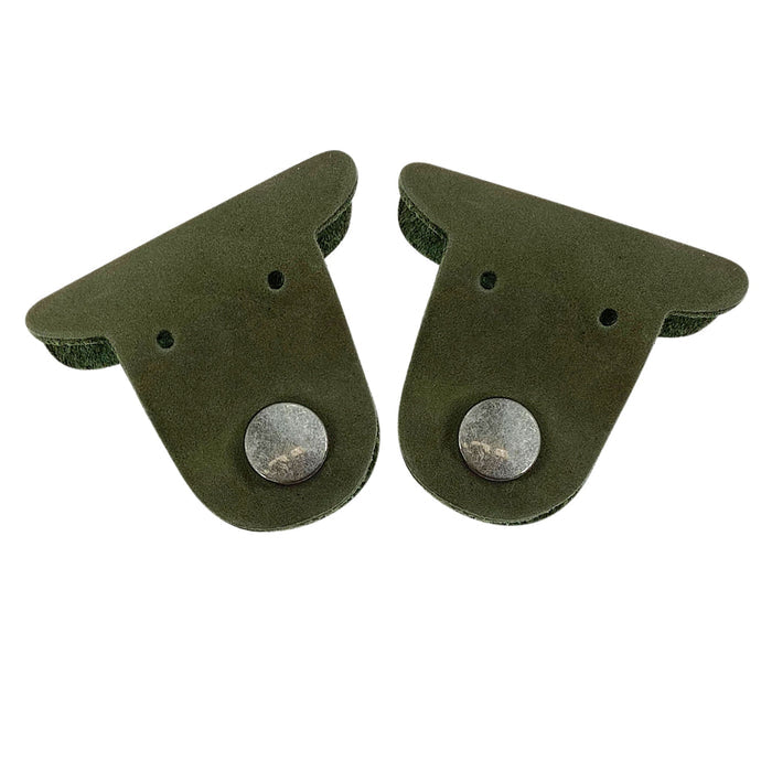Two green Dog Cord Keepers by Taco Dog, designed to keep your cords tangle-free and organized. Crafted from full grain leather, these handmade accessories clip together for easy management in travel. Experience the artisan craftsmanship of La Antigua Guatemala with this charming 2 pack.