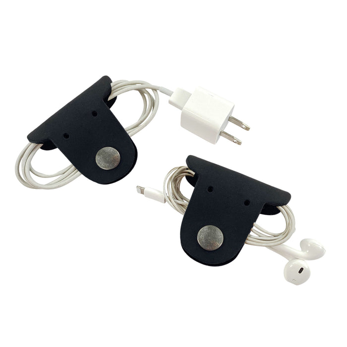 Wrap up your cables in style with Taco Dog's Dog Cord Keepers, perfect for organizing headphones and chargers. These full grain leather accessories feature durable clips for easy travel management. Experience artisan quality with each handmade piece from La Antigua Guatemala.