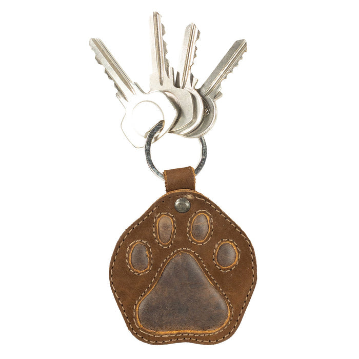 Dog Paw Keychain by Taco Dog, securely holding keys with a cute, stitched design. This charming key ring fob is made from durable full grain leather, making it a perfect gift. Artisan-made in La Antigua Guatemala & Oaxaca Mexico, it features a split keyring for easy attachment.