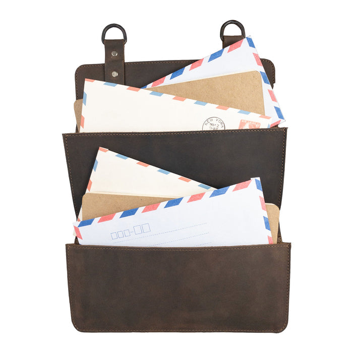 Hide & Drink Double Document Holder for Hanging displayed filled with letters, emphasizing its functionality as wall mount file storage. Made from full grain leather, this piece represents artisan craftsmanship with small batch production methods, hand cut, hand sewn, and fire branded, proudly handmade in La Antigua Guatemala & Oaxaca Mexico.