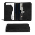 Black version of Hide & Drink's Double Passport Wallet W/Key Slot displaying slots for cards and bills, expertly crafted in a rustic full grain leather, ideal as a travel accessory for organized journeys.