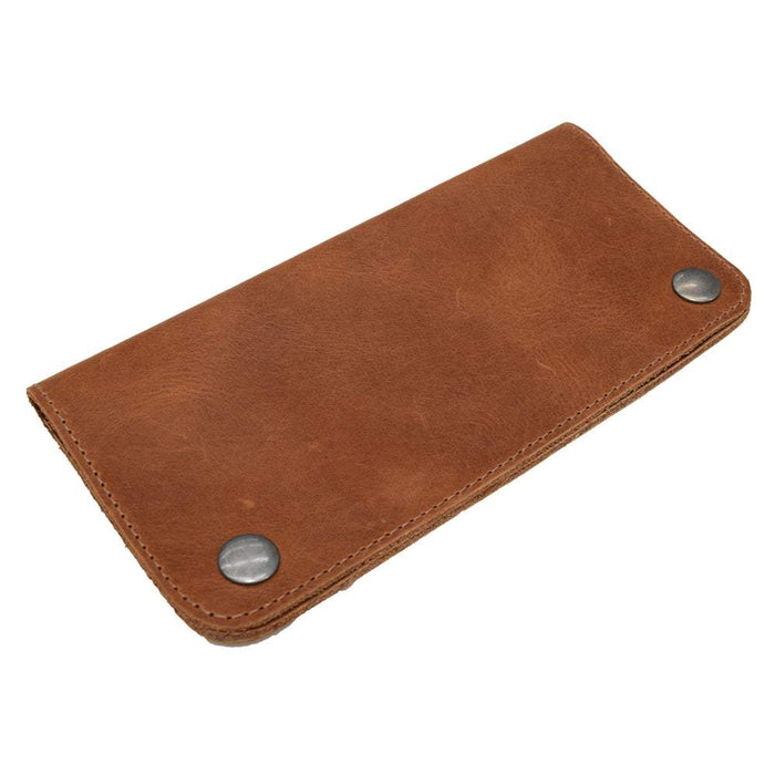 Side view of the Red Double Snap Folio Wallet by Hide & Drink, exhibiting its supple full grain leather. This artisan-crafted wallet serves as a stylish rectangular flat bill holder with card slot, perfect for a night bag or travel accessory, made with care in La Antigua Guatemala & Oaxaca Mexico.