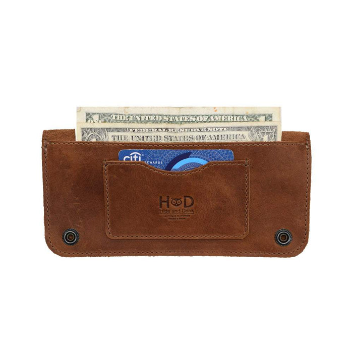 Inside view of the Brown Double Snap Folio Wallet by Hide & Drink, displaying its thoughtful layout for cash and cards. This full grain leather wallet, a great rectangular flat bill holder with card slot, acts as a stylish night bag or travel accessory, handmade in La Antigua Guatemala & Oaxaca Mexico.