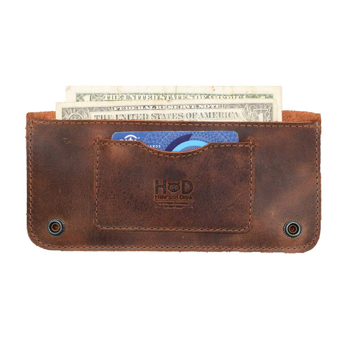 Front view of the Brown Double Snap Folio Wallet by Hide & Drink, highlighting its spacious card slot and cash area. This artisan-crafted full grain leather wallet is a stylish night bag and travel accessory, blending form and function seamlessly. Made in La Antigua Guatemala & Oaxaca Mexico, it showcases the excellence of small batch production.
