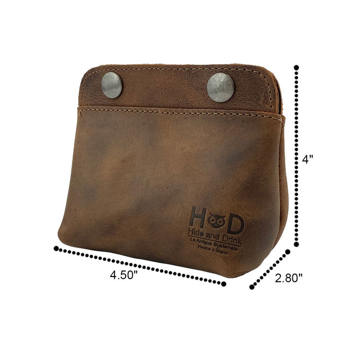 Hide & Drink Double Snap Pouch alongside a measuring scale, illustrating its practicality as a coin purse, cash & card holder, and cable organizer. This artisan-crafted full grain leather piece is perfect for organizing small essentials.