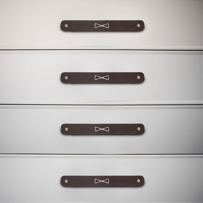 Rectangular Drawer Handles with Bowtie Stitching Design installed on a dresser, showcasing the craftsmanship of Hide & Drink. This 4 Pack of full grain leather handles adds a touch of handmade elegance from La Antigua Guatemala & Oaxaca Mexico.