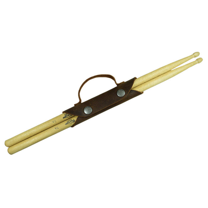 The Hide & Drink Drumstick Holder featured with two classic Drumsticks, demonstrating its practical use as an Organizer Case. Made from durable Full Grain Leather, this Drummer Essential emphasizes hand-crafted quality through Small Batch Production techniques, reflecting the Artisan skills of local makers in La Antigua Guatemala & Oaxaca Mexico.