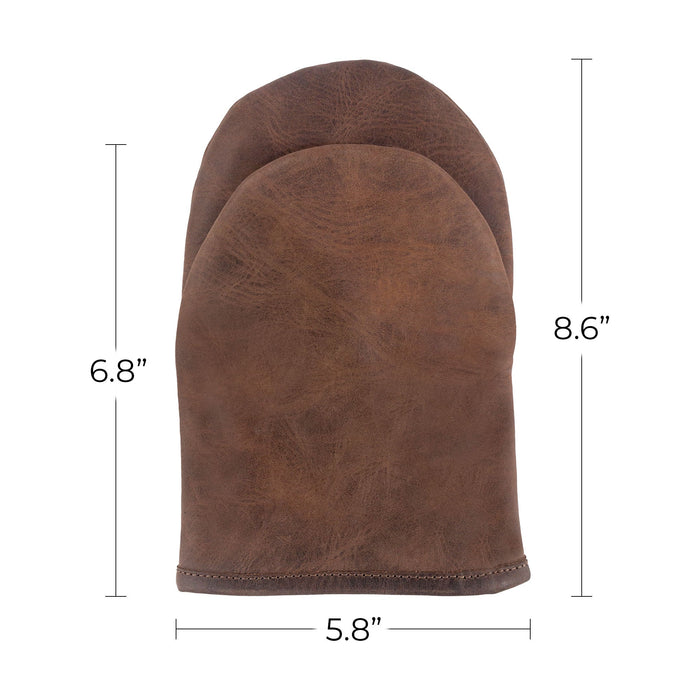 Detailed view of the Cast Leather Co. Dual-Hand Leather Oven Mitt alongside product tags, emphasizing its artisan quality and craftsmanship. This heat-resistant oven glove made from Full Grain Leather is a must-have for any kitchen, proudly handmade in La Antigua Guatemala & Oaxaca Mexico.