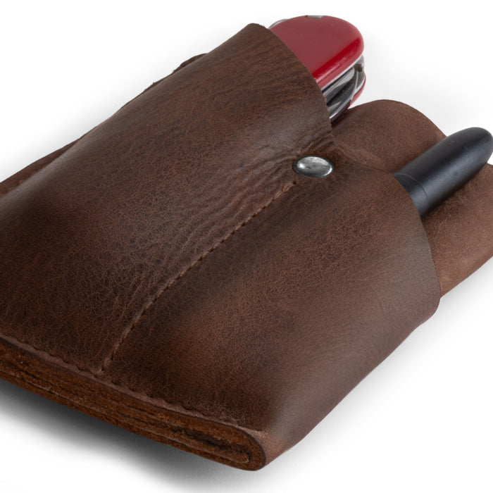 Close-up of the EDC Pocket Wallet by Hide & Drink, displaying its practical design and soft full grain leather finish. This handmade wallet acts as a multitool pouch, card holder, and money organizer, ideal for travel. Crafted in small batches, it's hand cut, hand sewn, and fire branded in La Antigua Guatemala & Oaxaca Mexico.