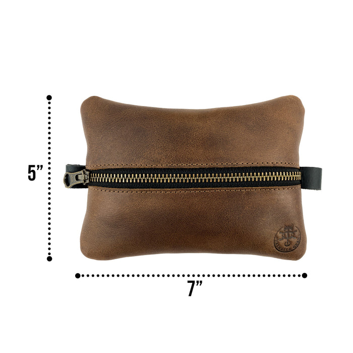 Dimensions of the EDC Zippered Pouch by Valhalla Gear, showcasing its compact size of 5 inches tall and 7 inches wide. This versatile accessory bag is crafted from full grain leather, perfect for storing essentials and small personal items, highlighting small batch artisan production in La Antigua Guatemala.